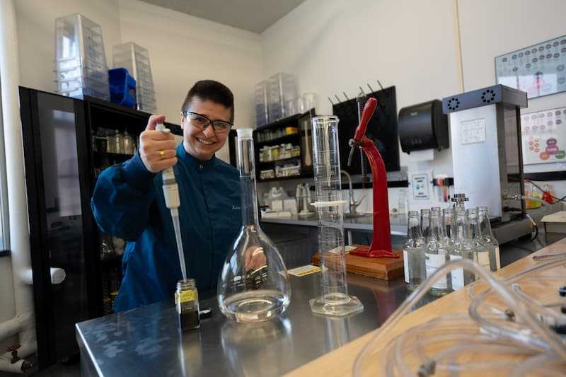 Photo of a person performing quality tests in a laboratory setting Photo of a person performing quality tests in a laboratory setting